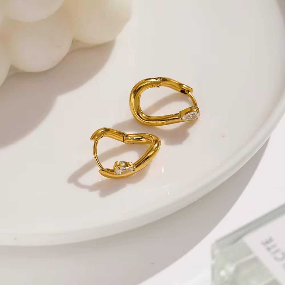 Abstract gold earrings with gem
